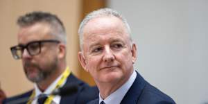 Justin Stevens (background) and Hugh Marks at an estimates hearing in December.