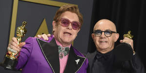 Elton John and Bernie Taupin celebrate their Oscars for (I’m Gonna) Love Me Again from Rocketman in 2020