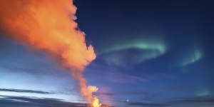 Lava flowing from the volcano was backdropped by the northern lights on March 24.