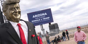 An attendee walks past a statue of Donald Trump before a rally for the former president in Florence,Arizona,in 2022.