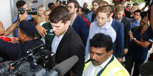 James Paver,centre left,Nick Kelly,centre with glasses,and Thomas Whitworth,centre right,of the nine Australian men arrested are escorted to the Sepang Magistrate in Sepang on Thursday.