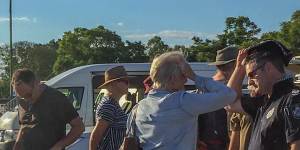 Police speaking to witnesses and convoy members after the incident.