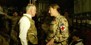 John Howard in a flak jacket prepares for the Anzac Day dawn ceremony in Baghdad,2004. 
