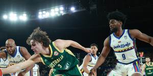 Josh Giddey stretches for the ball for the Boomers in Monday’s game against Venezuela,ahead of opponent Pedro Chourio.