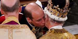 Prince William kisses his father,King Charles III,during the coronation ceremony.
