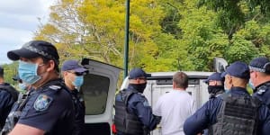 Police arrest one of the demonstrators on Monday.