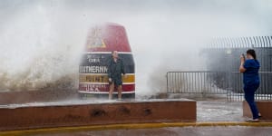 Visitors to the Southernmost Point buoy brave the waves made stronger from Hurricane Idalia.