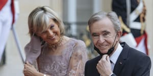 LVMH chief Bernard Arnault,with wife Helene,is the world’s richest person.