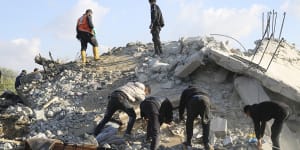 Palestinians search for survivors after an Israeli airstrike on a residential building In Rafah,Gaza Strip on Saturday.