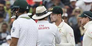 Cameron Bancroft talks to the umpires as he is sprung with sandpaper in Cape Town.