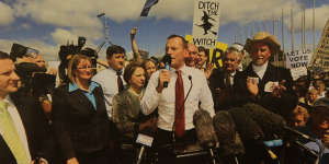 Then-opposition leader Tony Abbott addresses an anti-carbon tax rally in 2011,amid posters vilifying Gillard as prime minister.