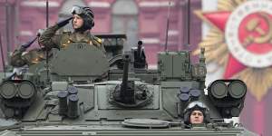 Russian military vehicles roll across the red Square ahead of Vladimir Putin’s speech. 
