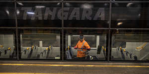 A cleaner on a Tangara train at the Mortdale depot. 