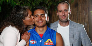 Jamarra Ugle-Hagan poses for a draft night photograph with parents Alice and Aaron.