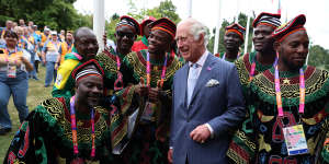 Britain’s Prince Charles poses with athletes and members of the team from Cameroon.