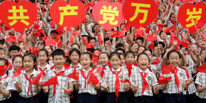 Primary school students sing together to celebrate the 100th anniversary of the founding of the Communist Party of China.