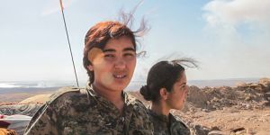 Fighters from the Kurdish People's Protection Units near a checkpoint in the outskirts of the destroyed Syrian town of Kobane,Syria in June. 