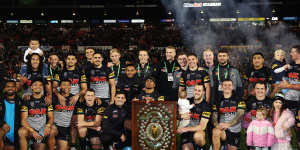Penrith pose with the minor premiership trophy after their win over the Warriors.