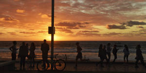 Dawn in Manly saw hundreds of residents on the promenade exercising and walking dogs. Coronavirus Photo Nick Moir 27 March 2020