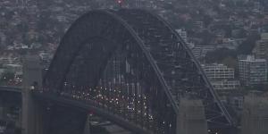 The Sydney Harbour Bridge’s flags at half-mast just after 6am.