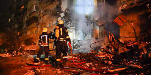 Firefighters inspect the damage at a building following a rocket attack on the city of Kyiv,Ukraine.