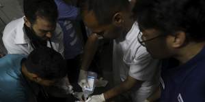 Palestinian medics treat a wounded child in Rafah,Gaza Strip on Saturday.