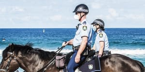 NSW Police patrol Bondi Beach as women sunbake.