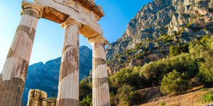 A greek temple at the base of a mountain range sundec8greece Greece ancient Olympia Peloponnese region Olympics;text by Steve McKenna;iStock*** REUSE PERMITTED***Â 