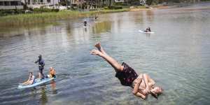 Swimmers enjoy the warm weather at Narrabeen Lakes on Sydney’s northern beaches on Sunday.