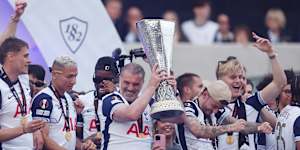 LONDON,ENGLAND - MAY 23:Ange Postecoglou,Manager of Tottenham Hotspur,lifts the UEFA Europa League trophy during the Tottenham Hotspur UEFA Europa League trophy parade on May 23,2025 in London,England. Spurs defeated Manchester United in the final in Bilbao on May 21 to win their first major trophy in 17 years. (Photo by Harry Murphy/Getty Images)