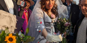 Stella Moris cuts her wedding cake outside Belmarsh Prison.