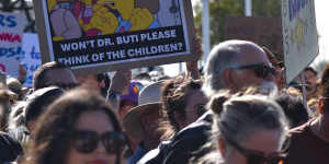 Another sign at the rally called on Education Minister Tony Buti to “think of the children”.
