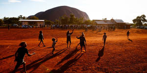 Local children play Aussies rules during the First Nations national convention at Uluru.