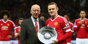 Wayne Rooney is presented with a trophy by Sir Bobby Charlton to mark his 500th game for Manchester United in 2015.