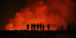 People watching the volcano north of Grindavík,Iceland. The eruption of the Sylingarfell volcano began at 6am local time on Thursday,soon after an intense burst of seismic activity.