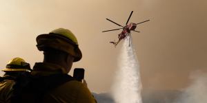 A helicopter drops water on the Palisades fire in Los Angeles at the weekend.