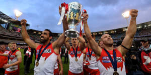 Tripping the light:Adam Goodes and Jarrad McVeigh hoist the premiership cup.