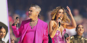 Robbie Williams with Delta Goodrem during the pre-match show.