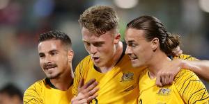 Goal-scorer Harry Souter,centre,with Socceroo teammates in 2019.
