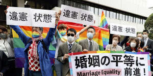 Plaintiffs hold banners reading “state of unconstitutionality” after the Tokyo District Court’s ruling on same-sex marriage in Chiyoda Ward,Tokyo,last November.