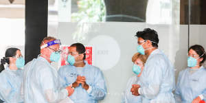 Hotel quarantine workers wearing full protective equipment at the Grand Hyatt Melbourne Hotel.