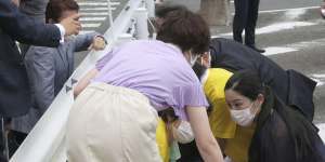 Shinzo Abe on the ground in Nara after being shot on Friday.