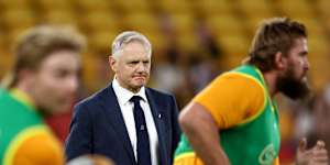 Wallabies coach Joe Schmidt watches the Wallabies warm up at Suncorp Stadium.