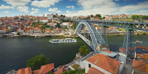 The Scenic Azure passes under the Dom Luis I Bridge in Porto.