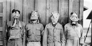 Men modelling gas masks used in World War I by (from left) American,British,French and German forces.
