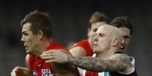 Zak Jones of the Saints tackles Luke Parker at Marvel Stadium. 