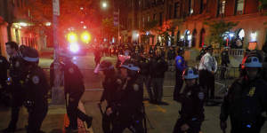 Members of the New York police strategic response team move towards an entrance to Columbia University.