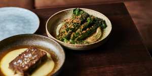 Charred sprouting broccoli on a bed of pale,creamy anchoiade showered with pangrattato.