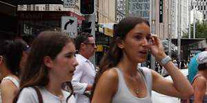 Pedestrians at the corner of George and Market streets.