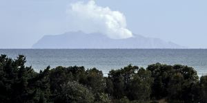 Plumes of steam rise above White Island off the coast of Whakatane,New Zealand,two days after a volcanic eruption on December 9,2019. 